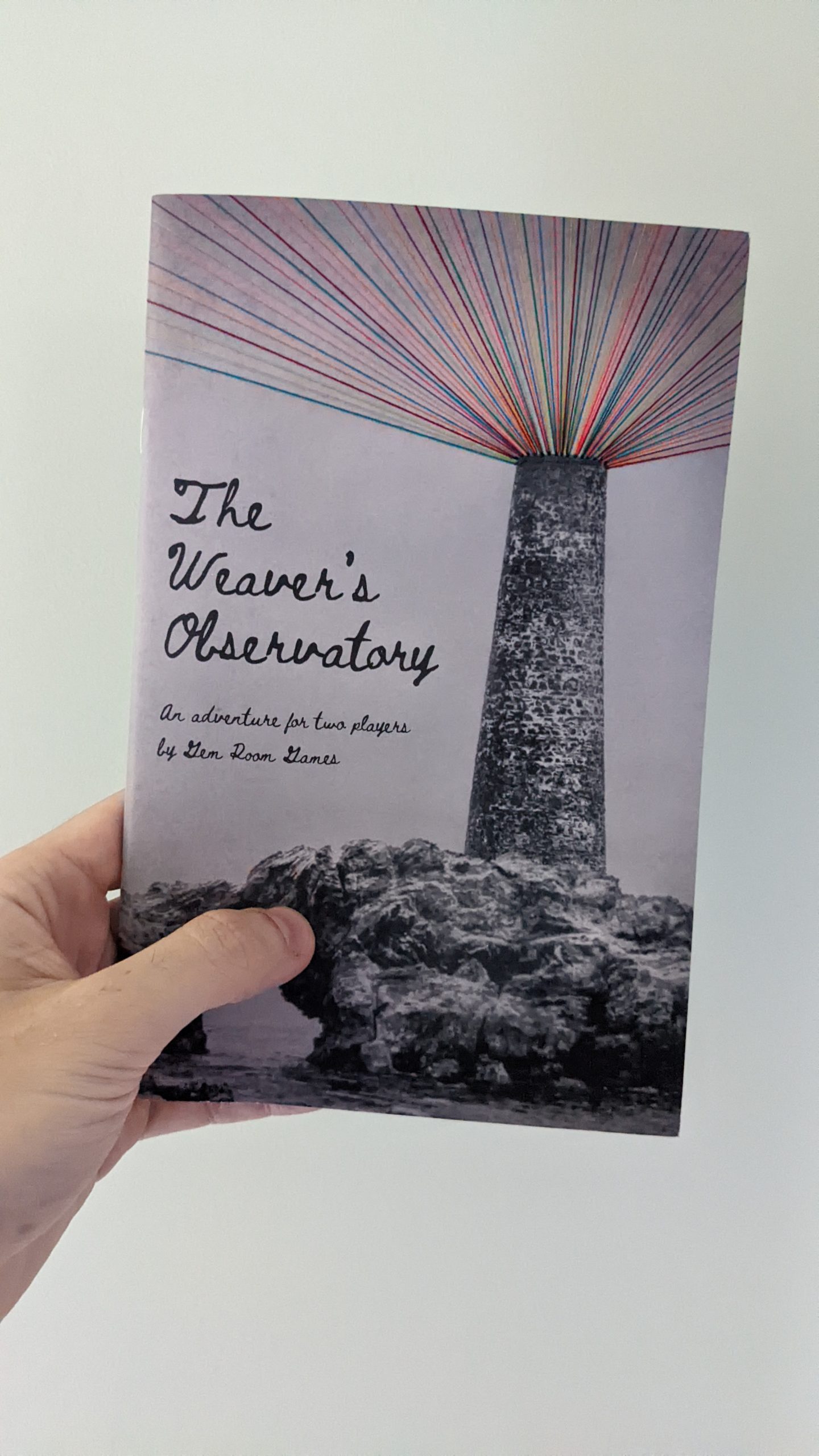 An A% zine. The cover shows a lighthouse with multicolour threads of string ascending from the cuppola. The title reads "The Weaver's Observatory".